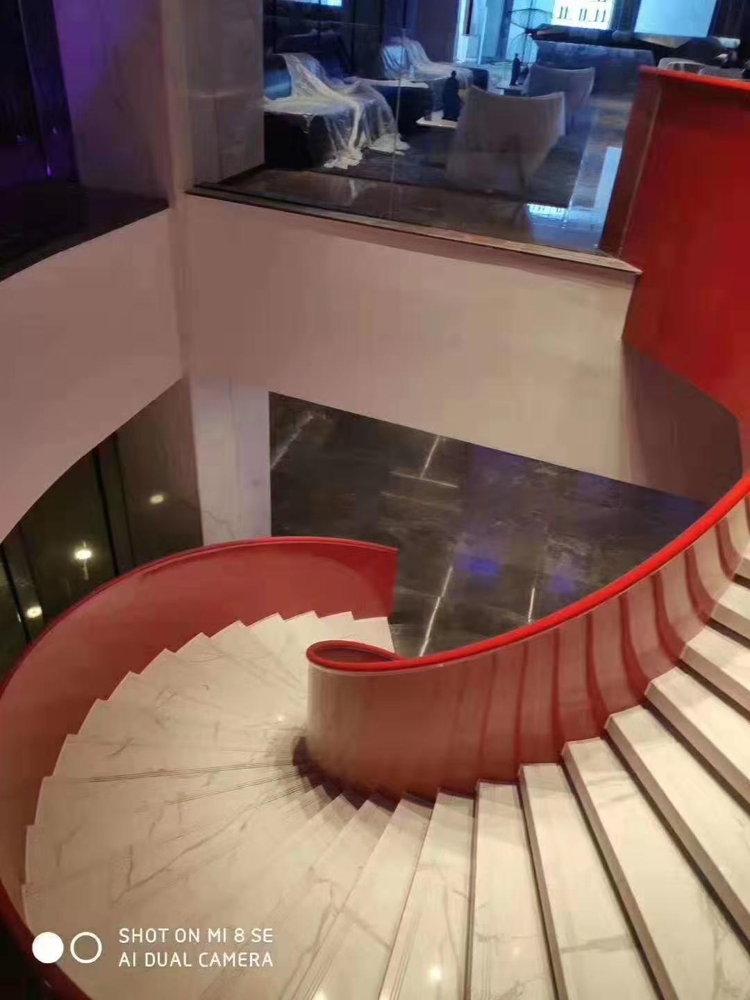 Contemporary double wood curved staircase